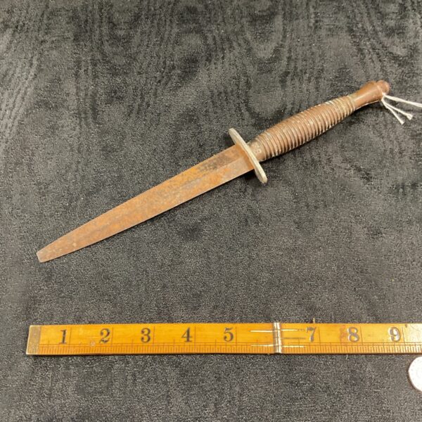 Vintage Fairbairn Sykes Commando dagger with textured grip and leaf-shaped blade.