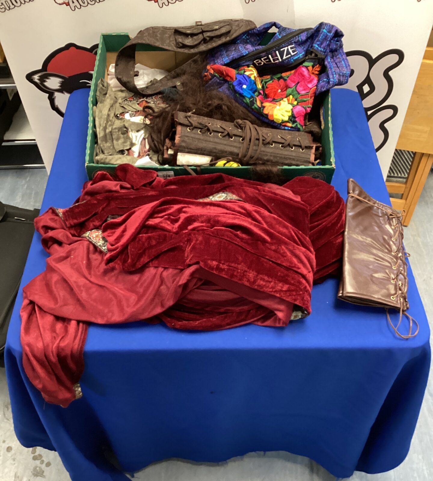 A colourful lot of fancy dress costumes including a hooded cape and corsets.
