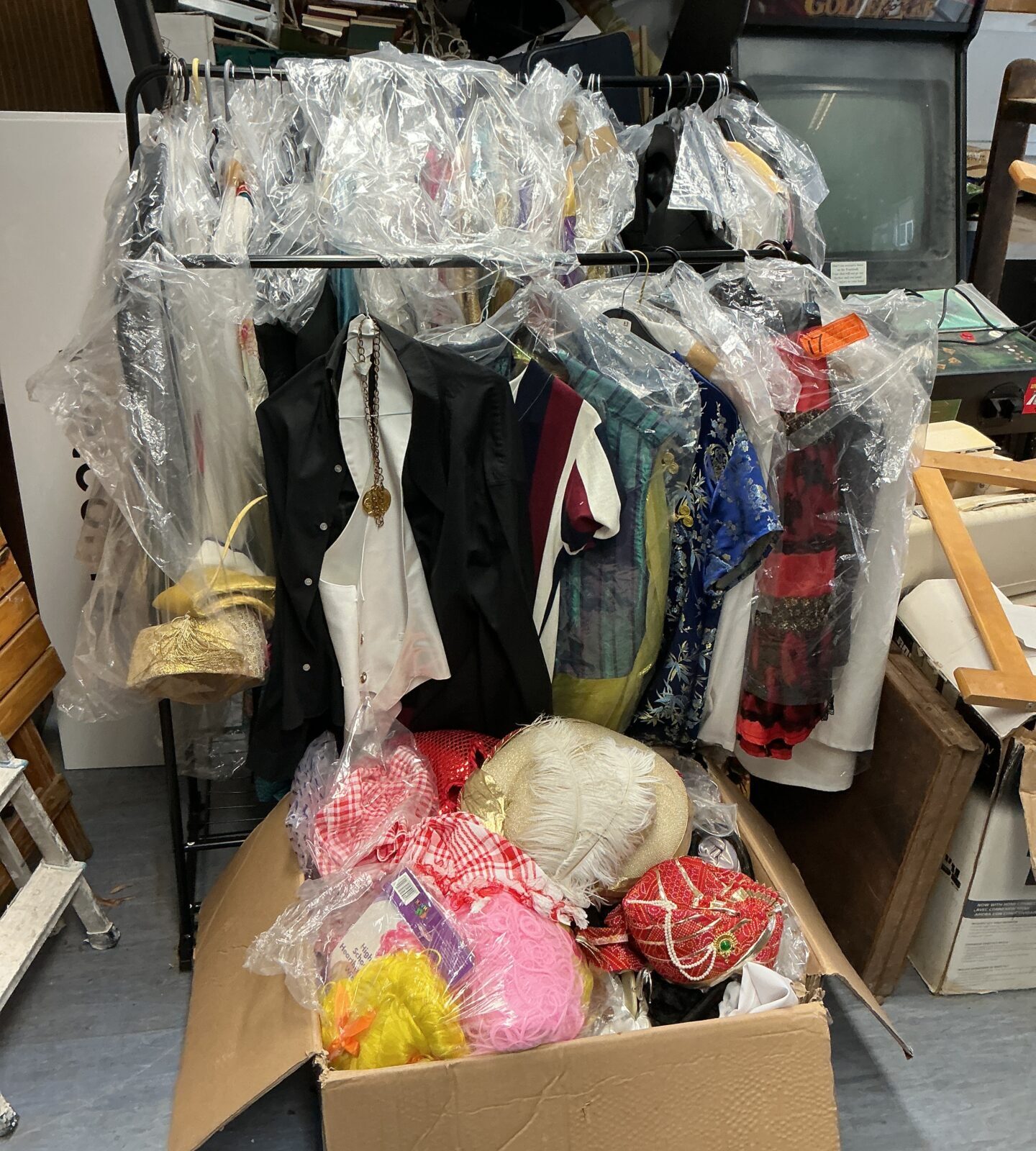 Large lot of diverse fancy dress costumes for various themes.