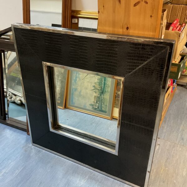 Large square faux leather and chrome framed mirror for modern home decor.