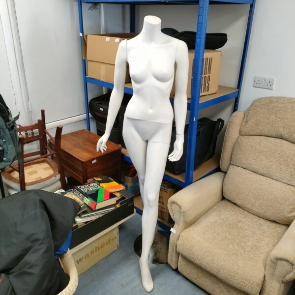 Full body female mannequin on glass base for retail display.