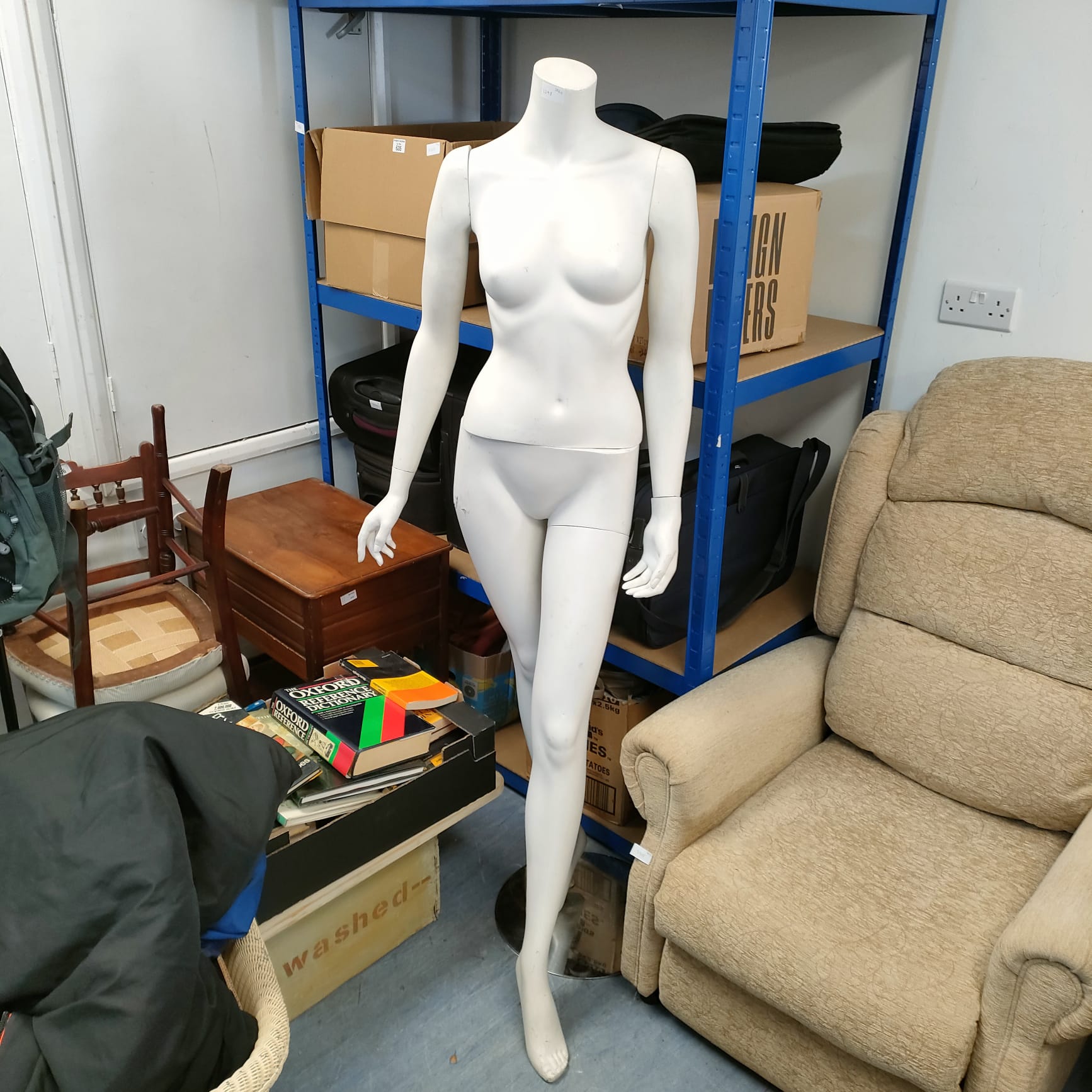 Full body female mannequin on glass base for retail display.