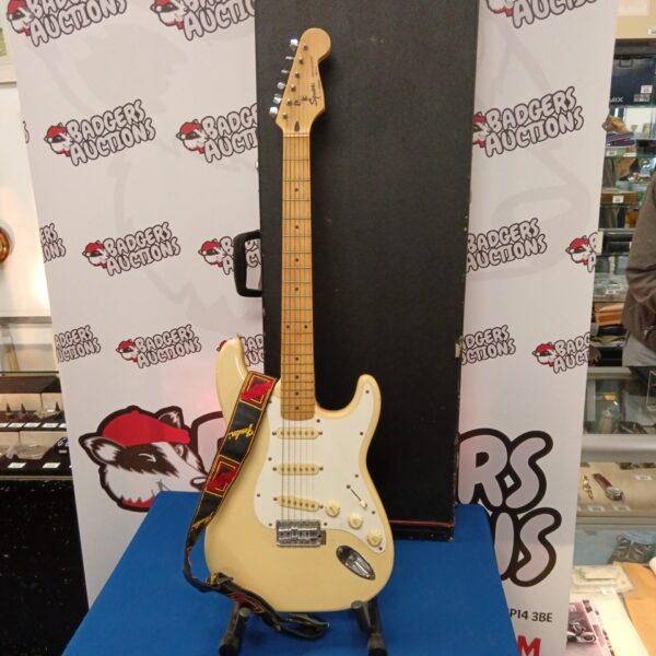 Sunburst Fender Squire Stratocaster electric guitar with hard case.