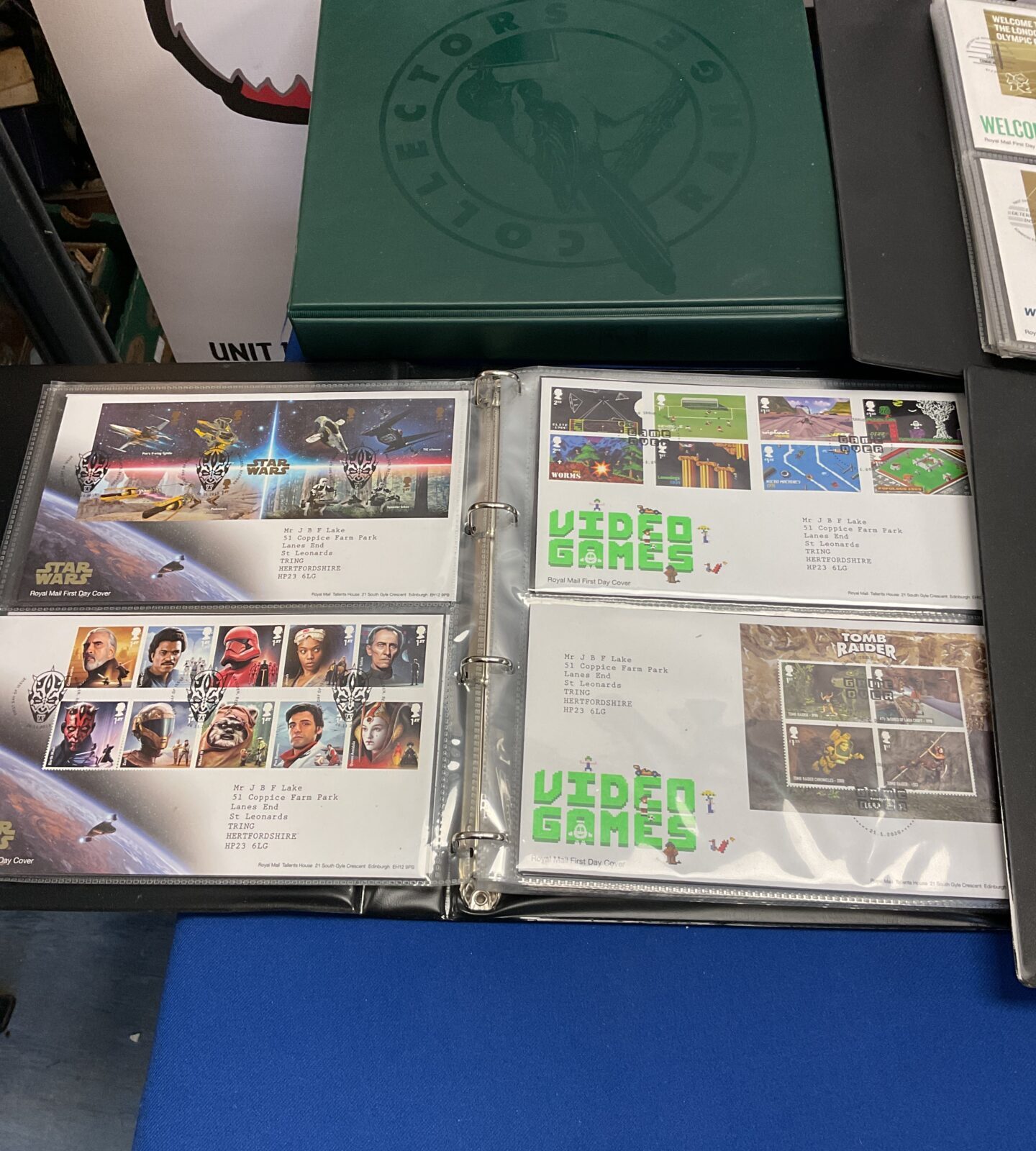 Close-up of First Day Covers within the albums, showcasing stamp details.