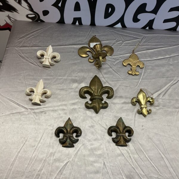 Vintage Fleur De Lis wall plates with intricate detailing.