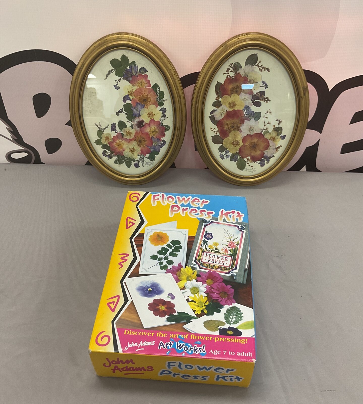 Vintage flower press with two framed dried flower pictures.