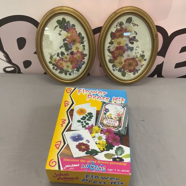 Vintage flower press with two framed dried flower pictures.