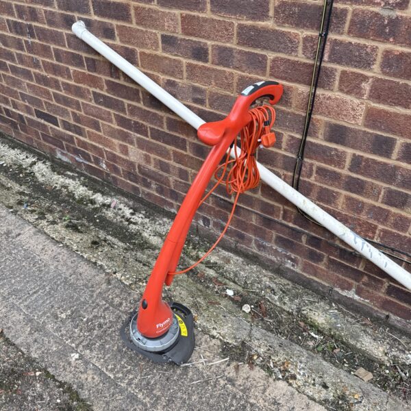 Red Flymo Contour XT electric strimmer for garden edging and lawn care.