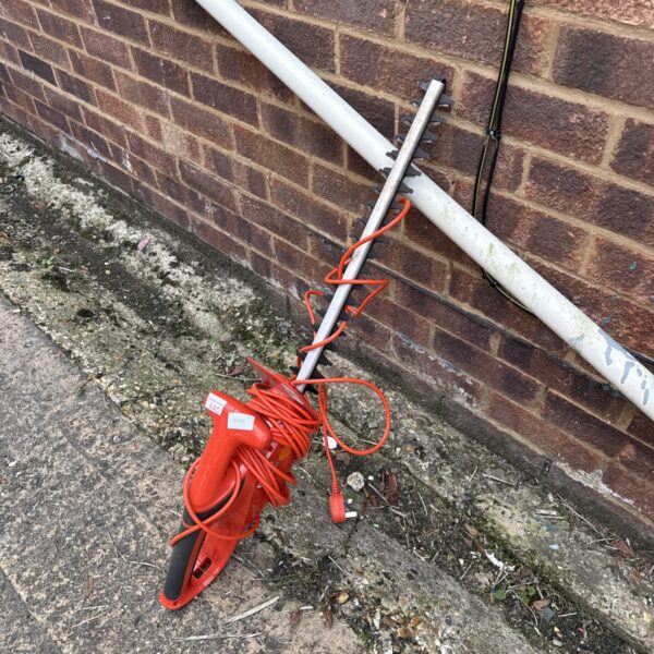 Flymo Easicut 460 electric hedge cutter for garden maintenance.