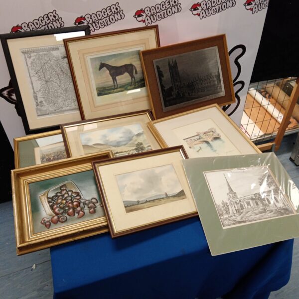 Collection of assorted framed prints and artwork on display.