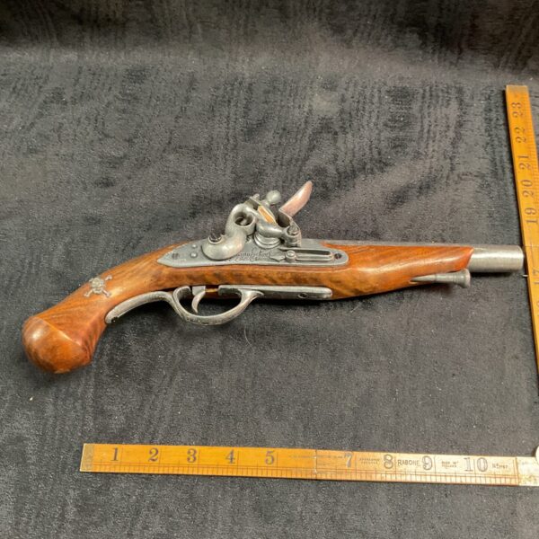 Detailed reproduction French flintlock pistol, ideal for collectors and display.
