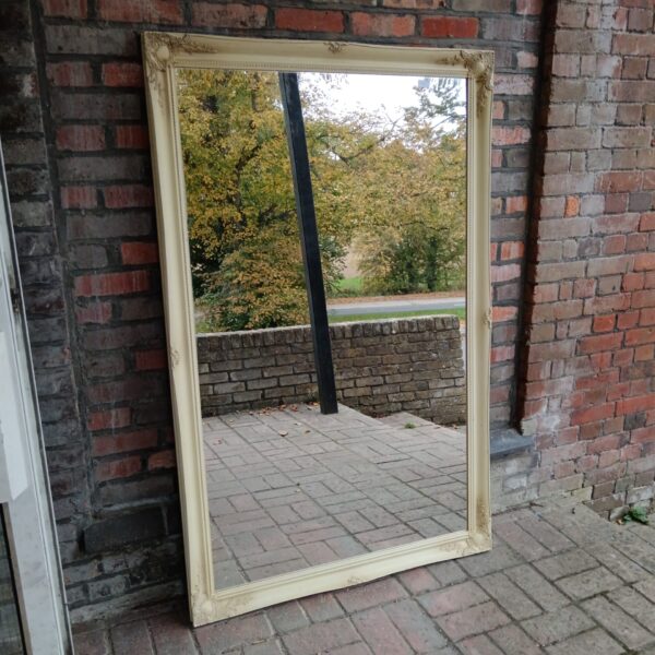 Large gilded French overmantle mirror with ornate detailing.