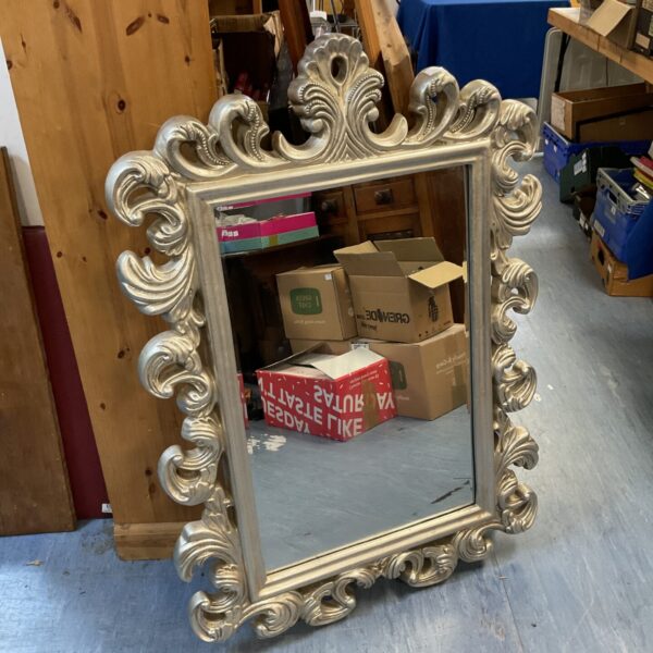 Ornate French style bevelled mirror with gold frame.