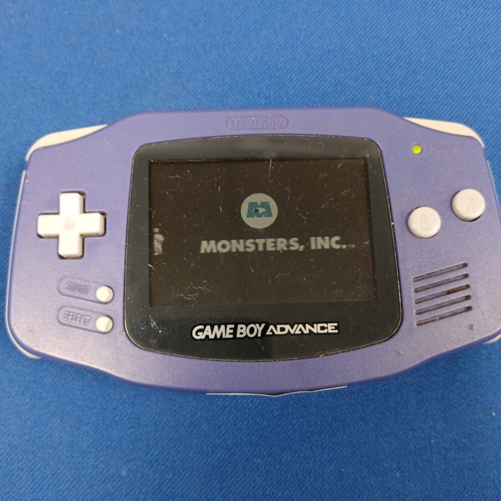 Game Boy Advance cartridges including Monsters Inc and Rayman.