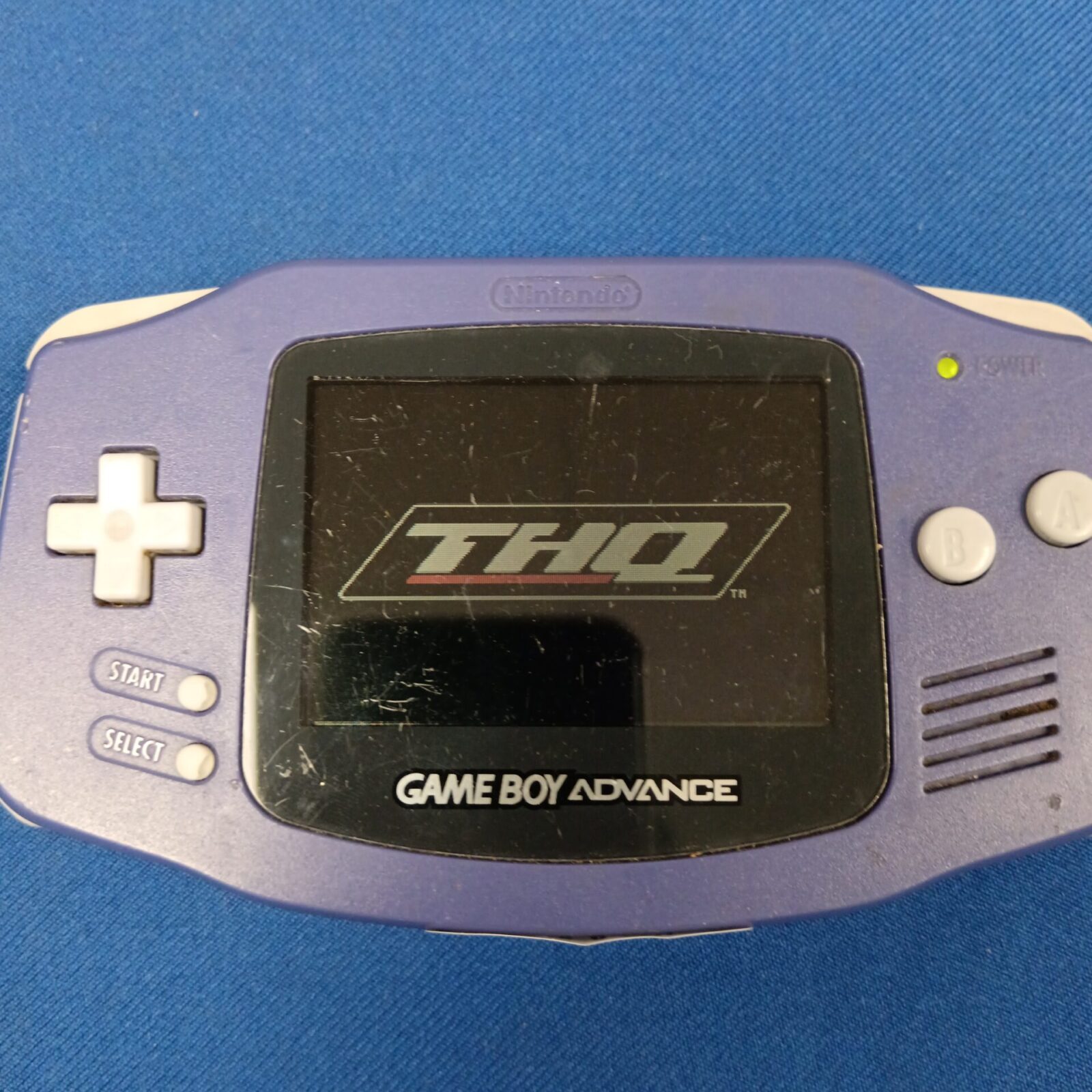 Close-up of Game Boy Advance screen showing THQ logo.