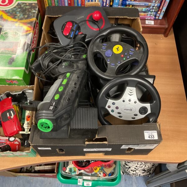 Collection of gaming steering wheels and accessories for racing games.