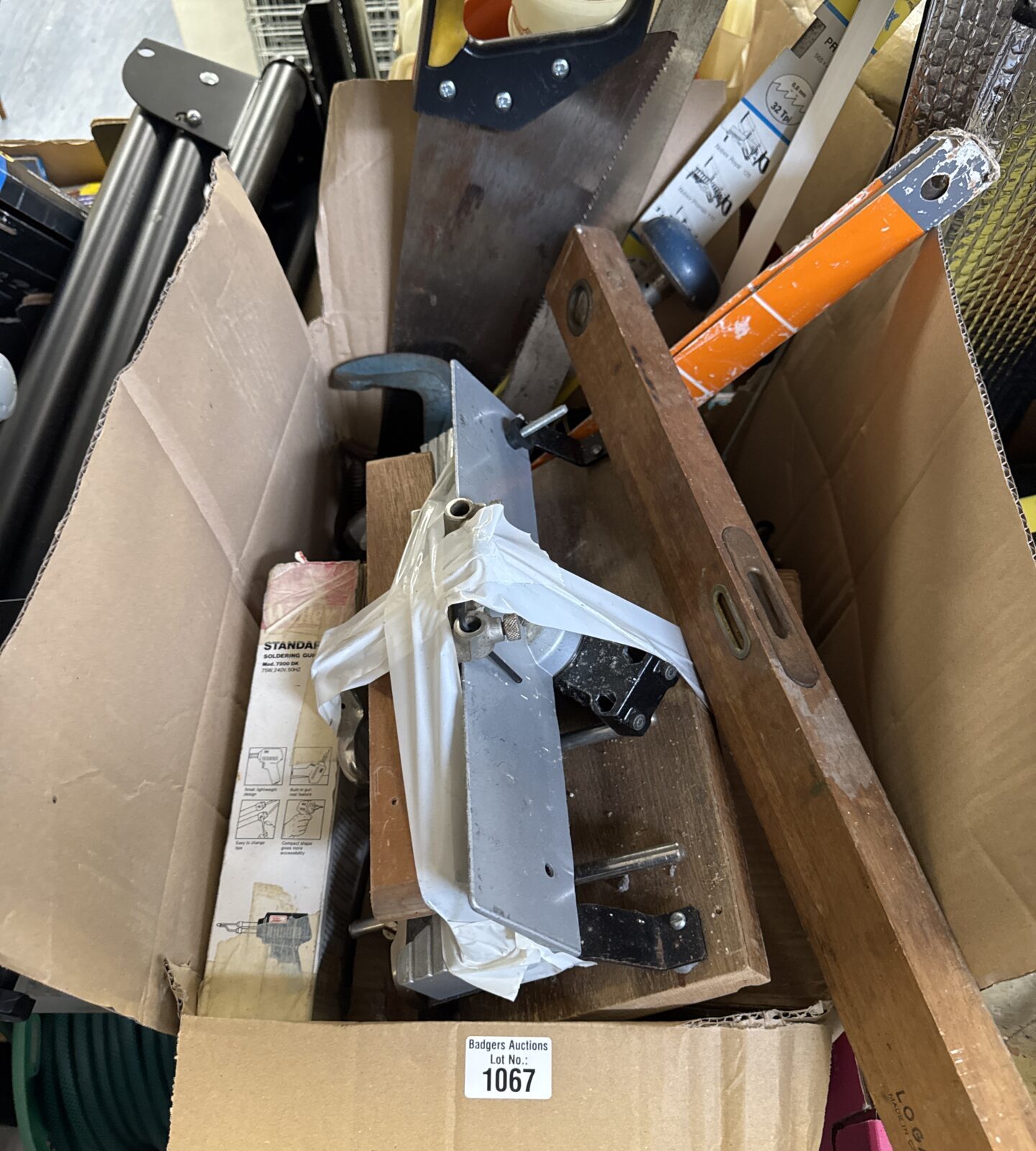 Mixed garage clearance lot with saws, drill and tools.