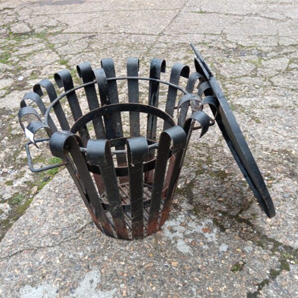 Wrought iron garden fire basket with lid for outdoor use.