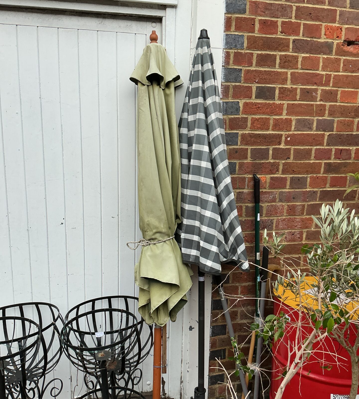 Green and white checked garden patio umbrella with stand.