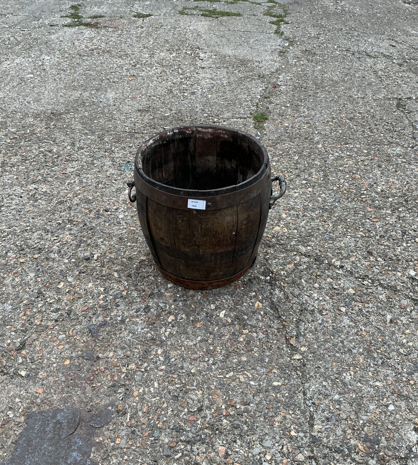 Rustic wooden garden planter barrel for outdoor use.