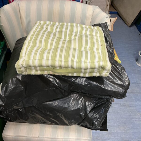 Floral garden seat cushions on a bench.