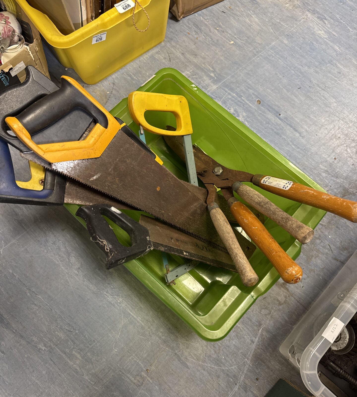 Vintage garden tools including saws and pruning clippers on display.