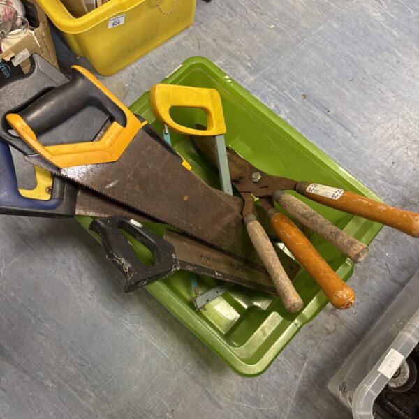 Vintage garden tools including saws and pruning clippers on display.
