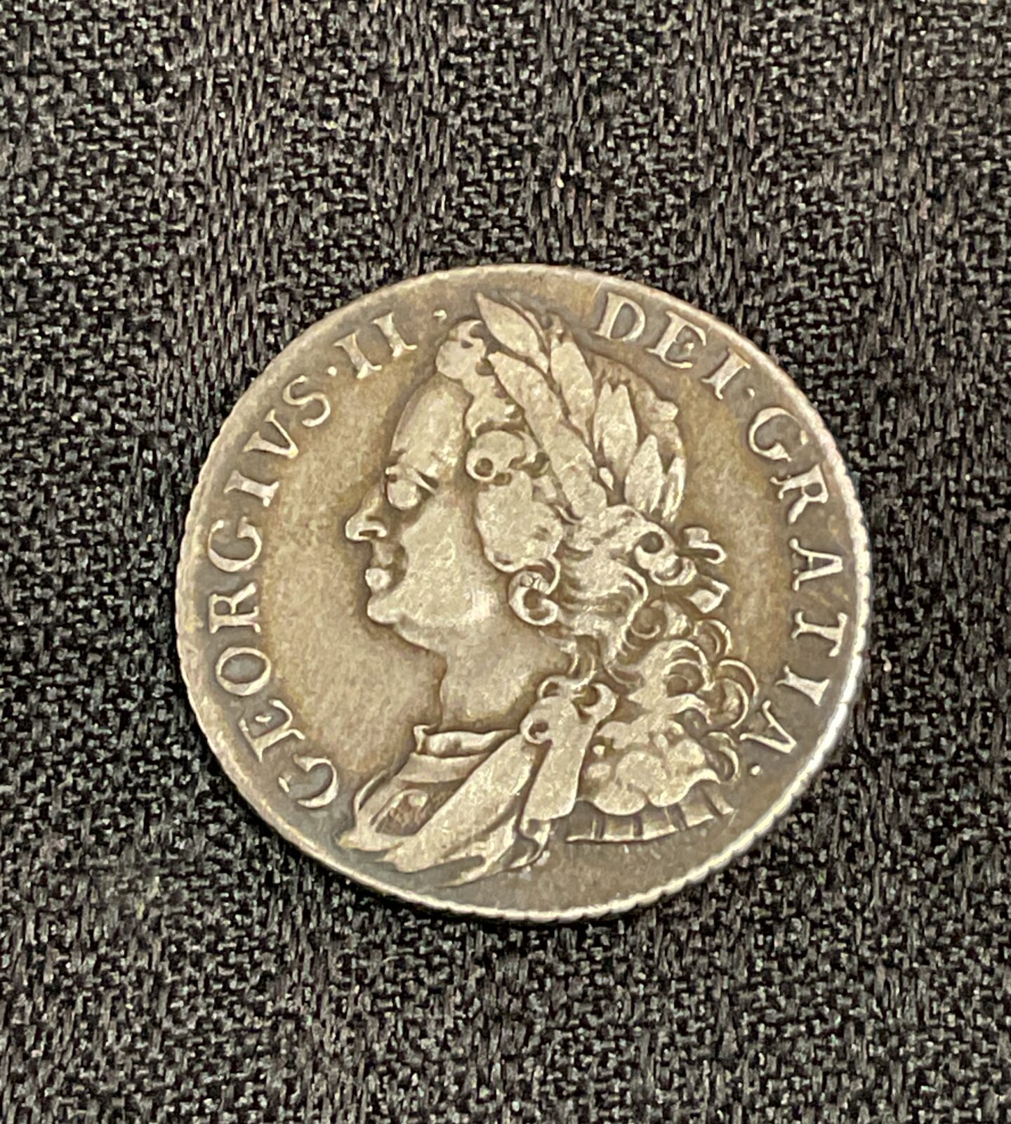 Reverse of a 1758 George II shilling coin with royal coat of arms.