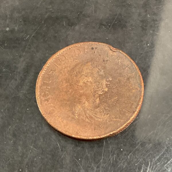 Obverse of a George III penny from 1799, showing the King's portrait.