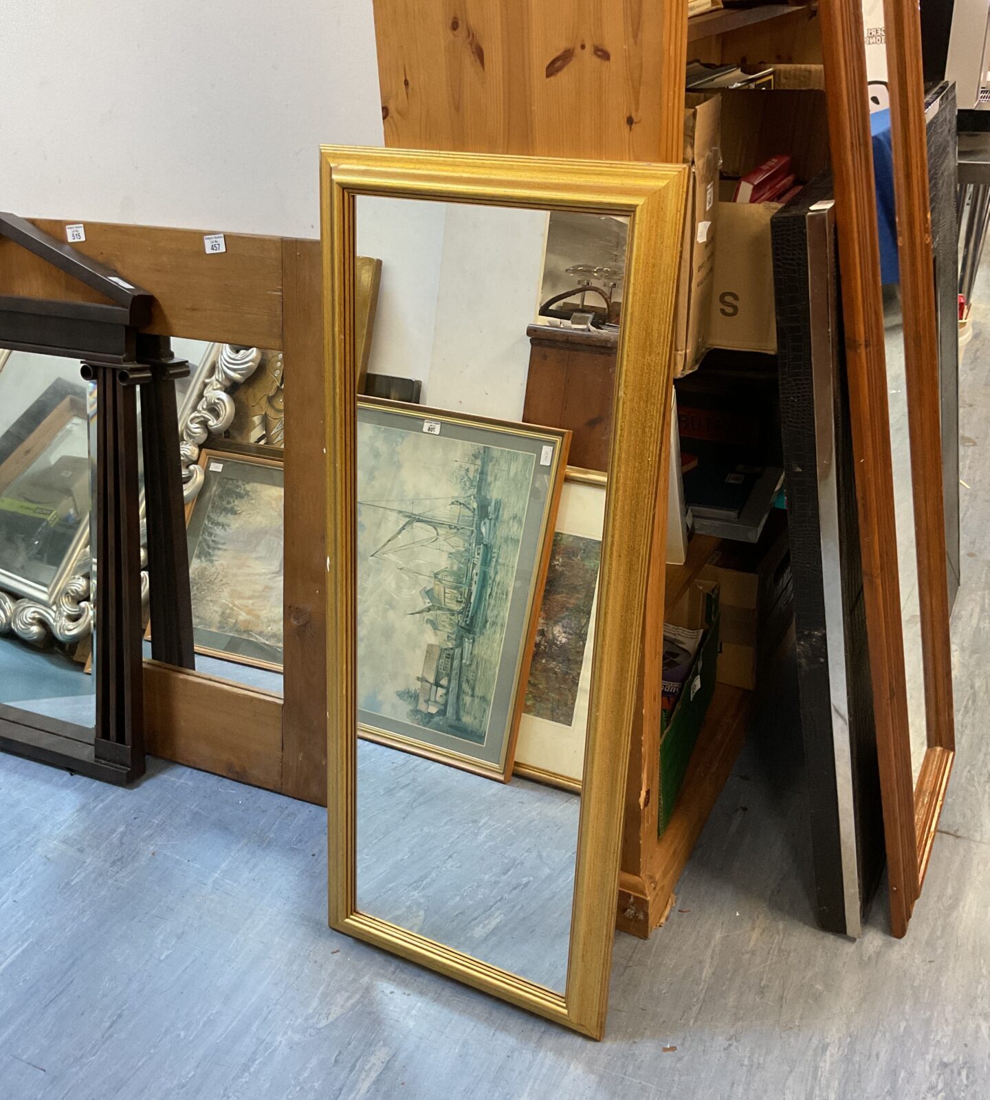 Ornate gilt framed bedroom mirror with a vintage aesthetic.