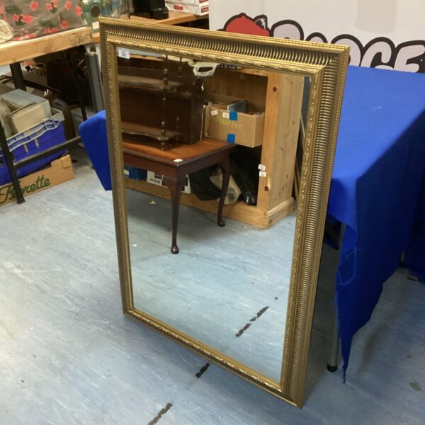 Ornate gilt framed mirror measuring 41” x 29” for wall decor.