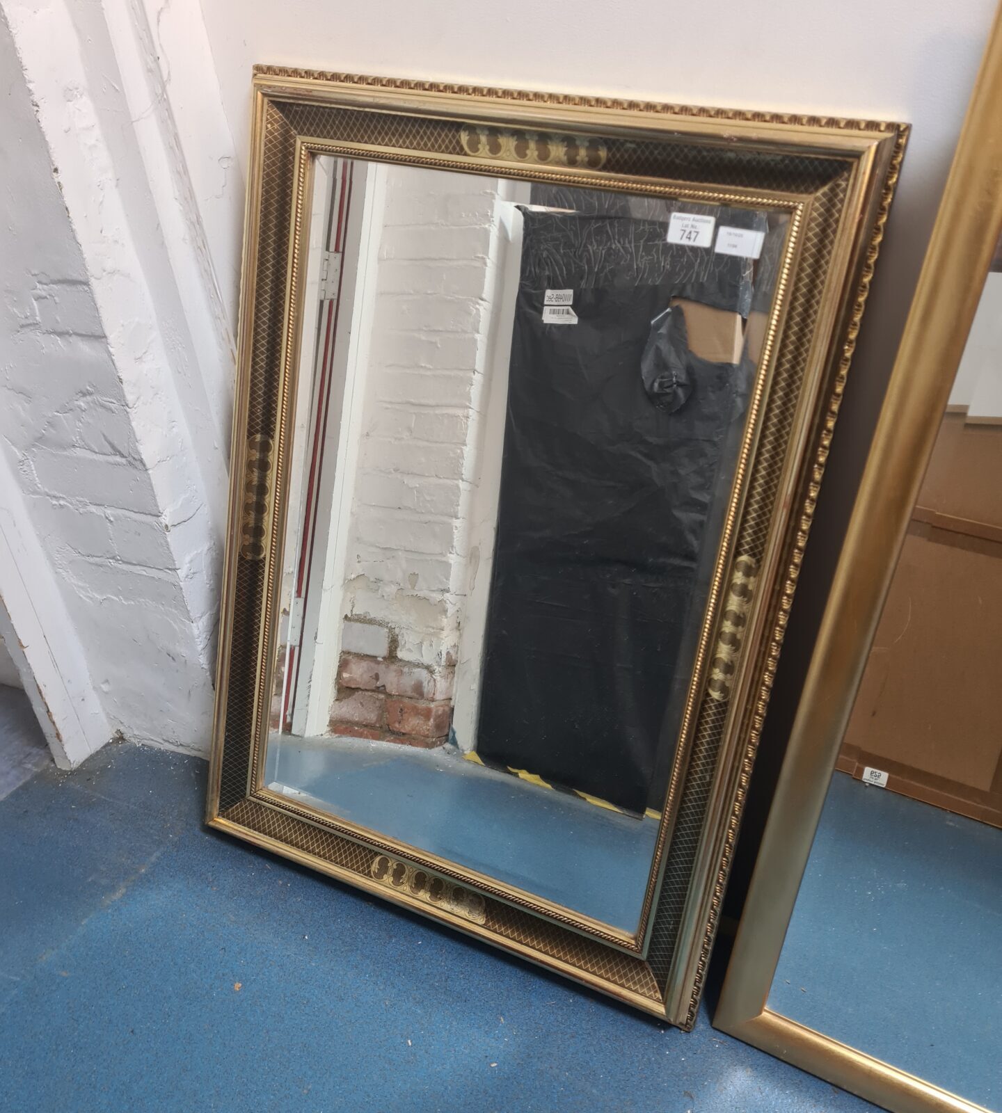 Ornate antique gilt framed mirror for wall decoration.