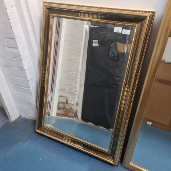 Ornate antique gilt framed mirror for wall decoration.