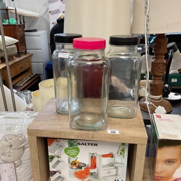 Lot of three clear glass storage jars for kitchen pantry.