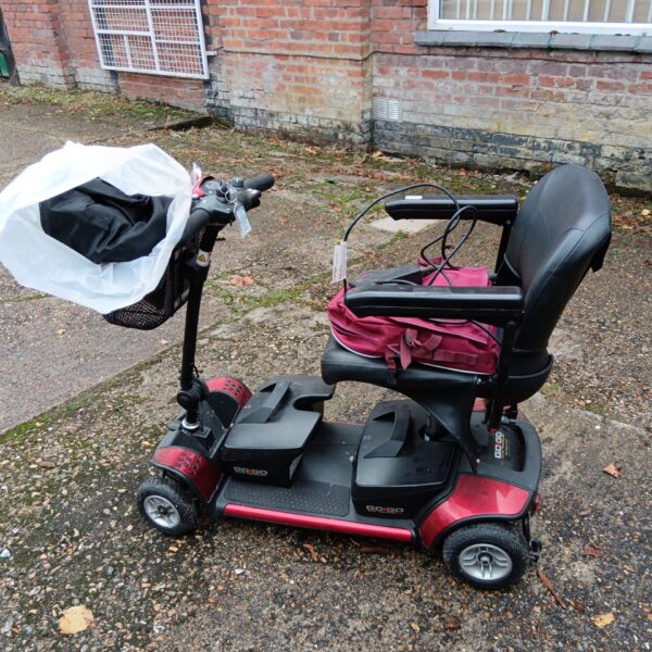Red Gogo Elite Traveller mobility scooter with accessories.