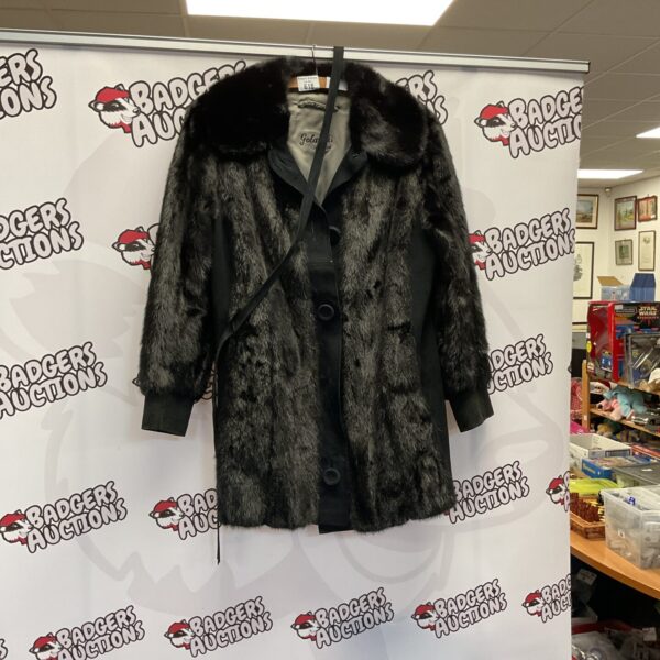 Front view of a luxurious Golanski London faux fur coat.