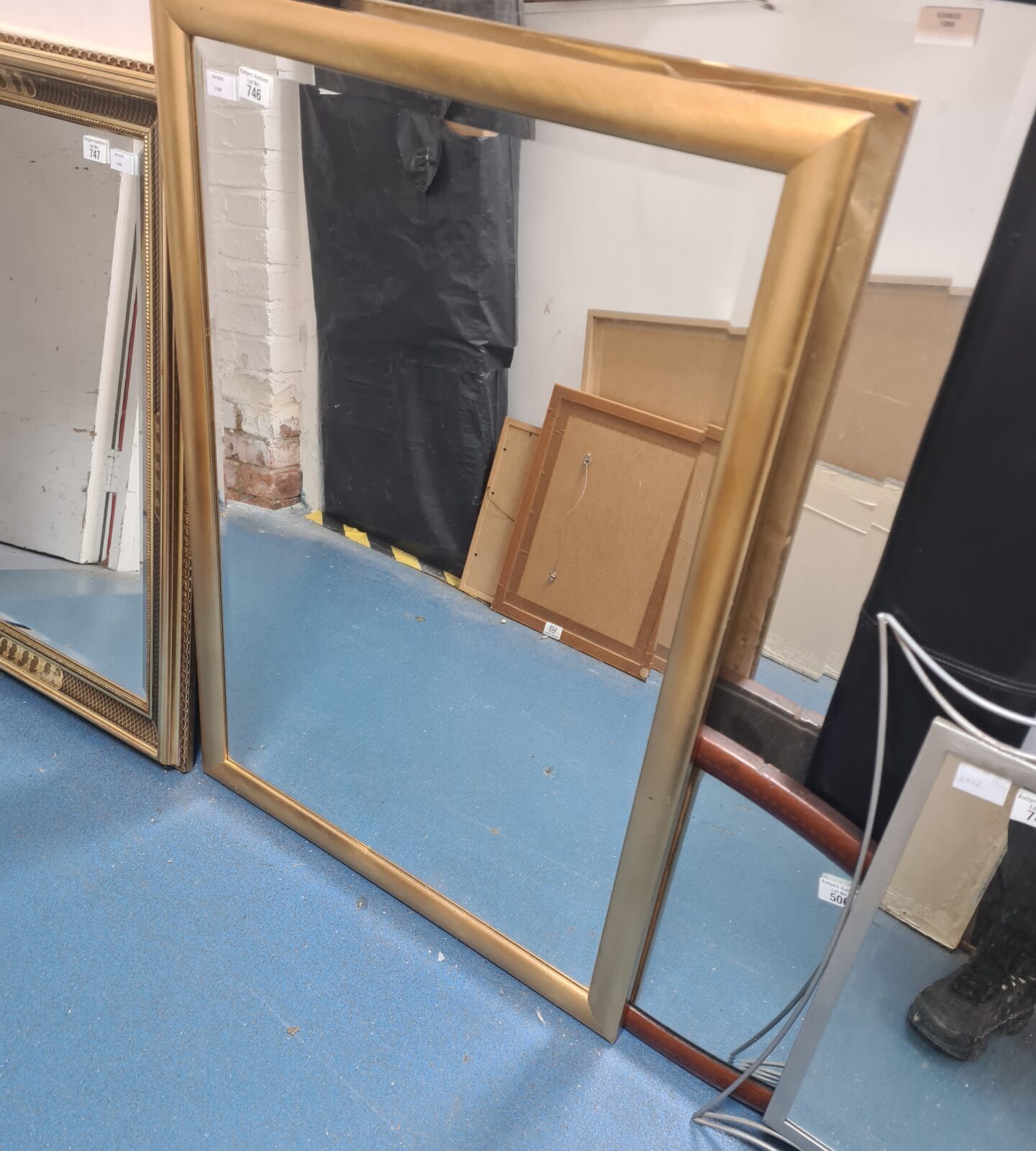 Elegant gold framed mirror with a vintage aesthetic.