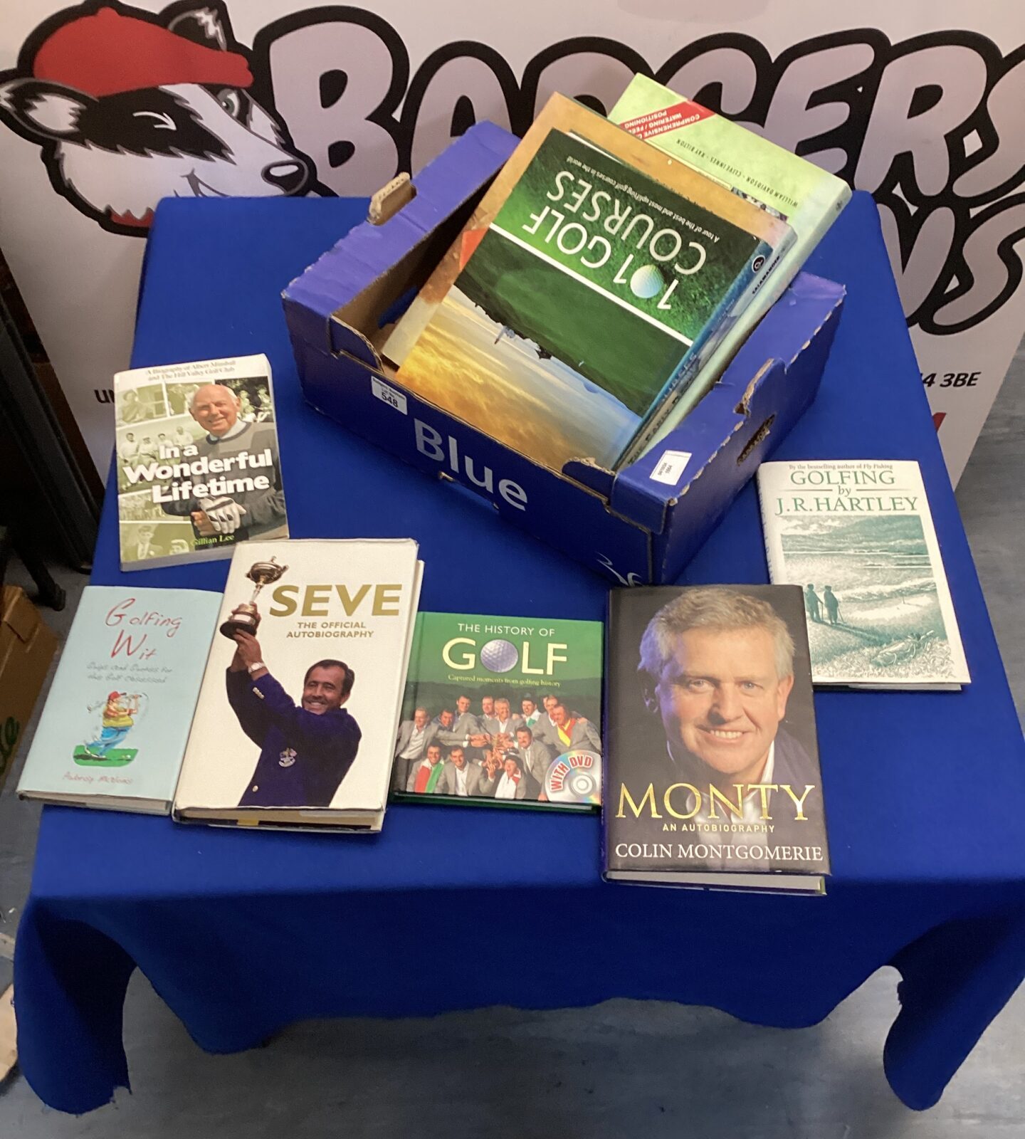 Stack of vintage and modern golfing books for collectors.