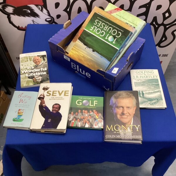 Stack of vintage and modern golfing books for collectors.