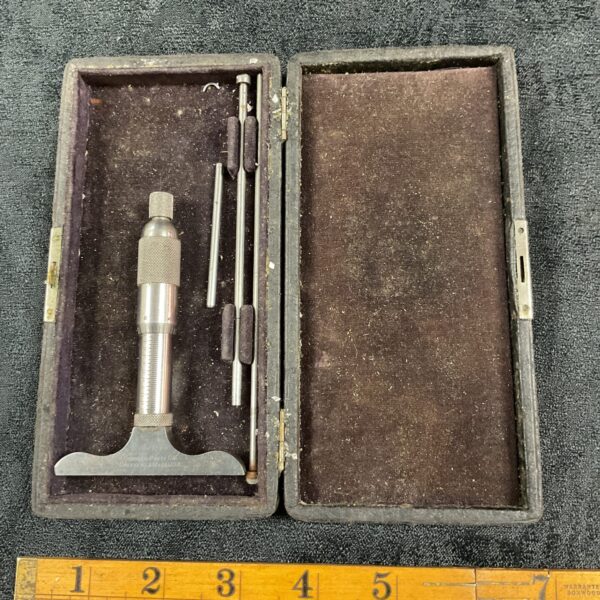 Open wooden case displaying a vintage Goodell Pratt depth micrometer.
