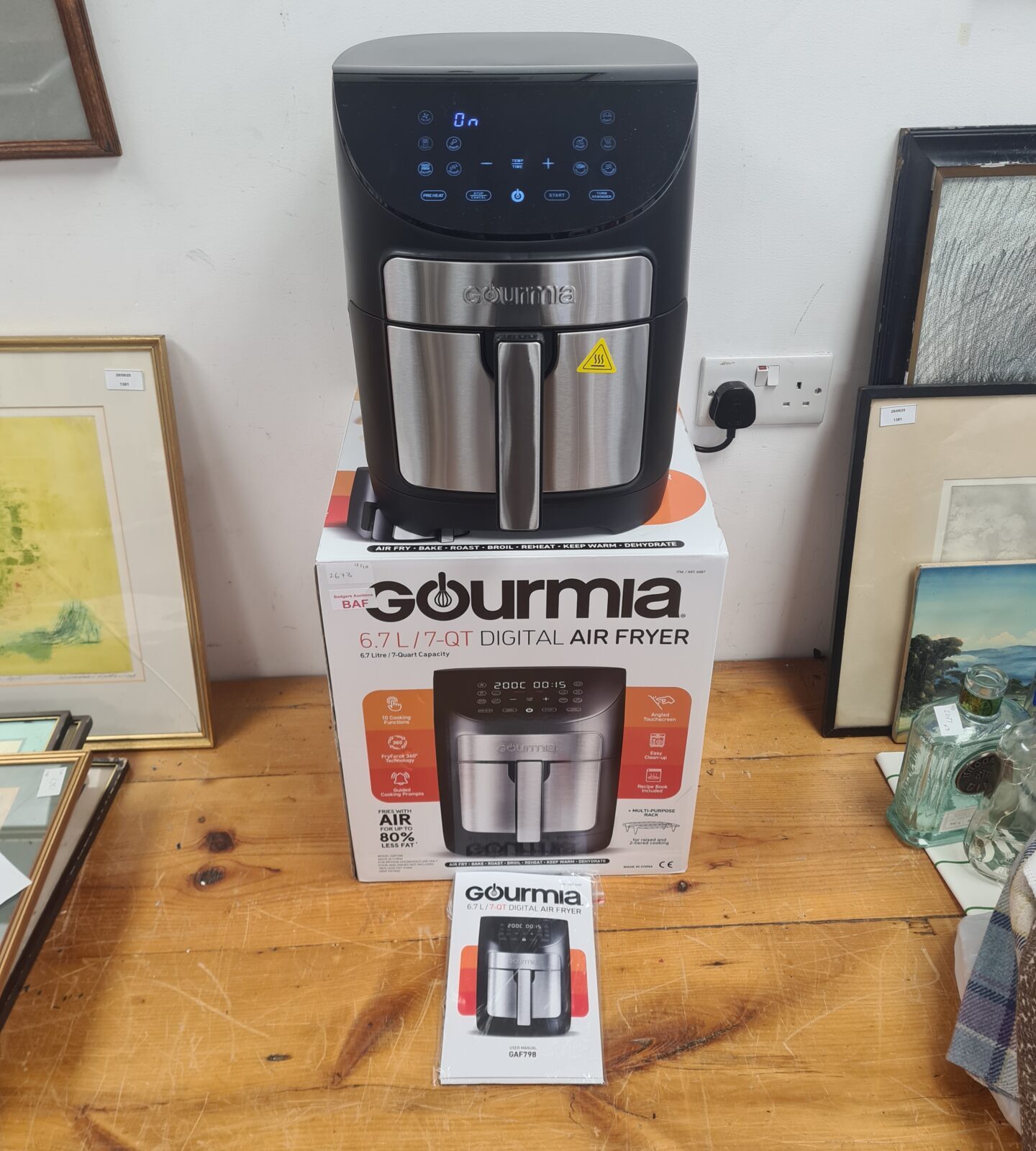 Boxed Gourmia 6.7L digital air fryer in a home setting.