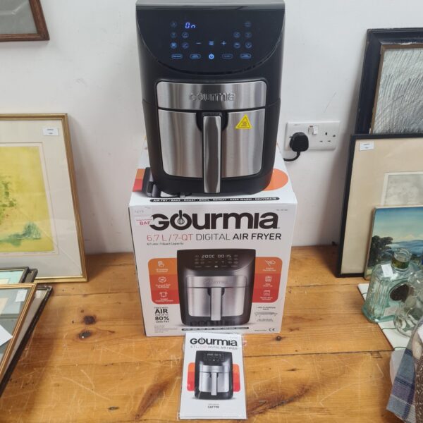 Boxed Gourmia 6.7L digital air fryer in a home setting.