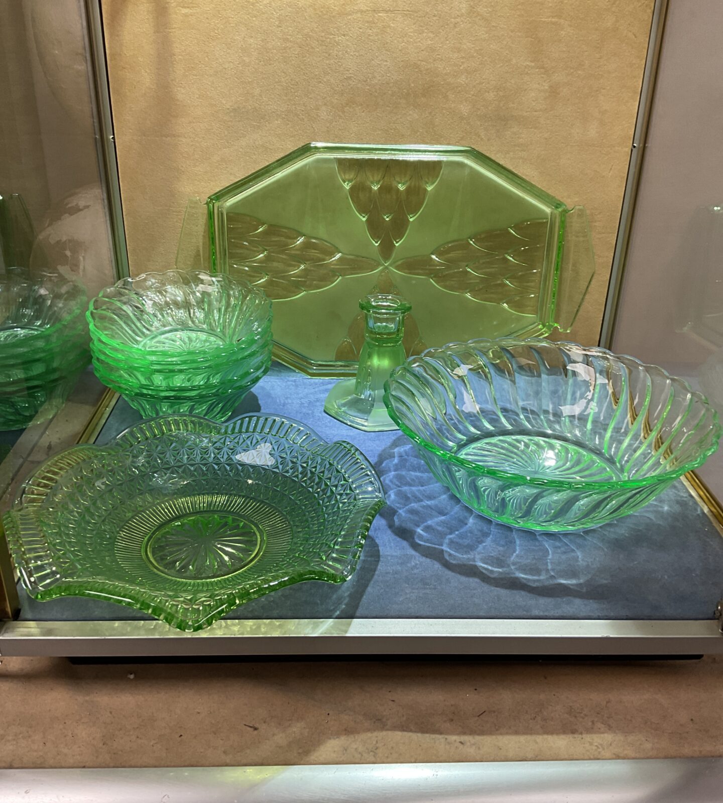 Vintage green glassware collection with pressed glass serving dishes.