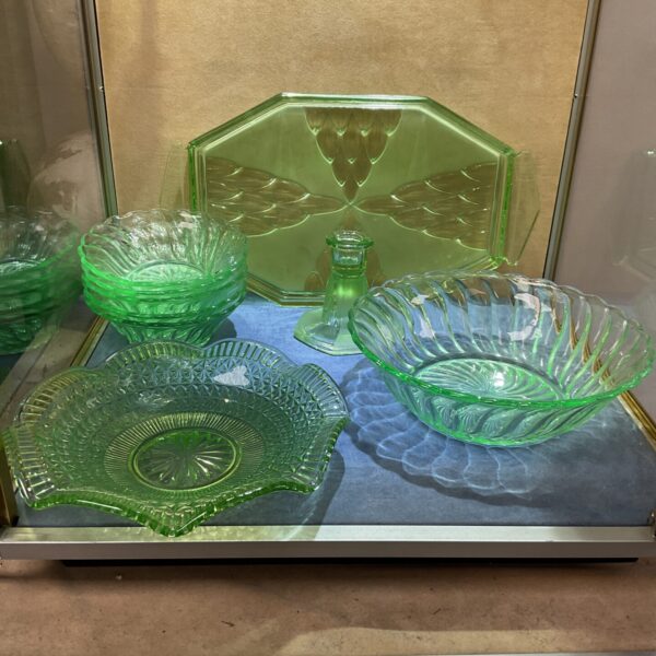 Vintage green glassware collection with pressed glass serving dishes.