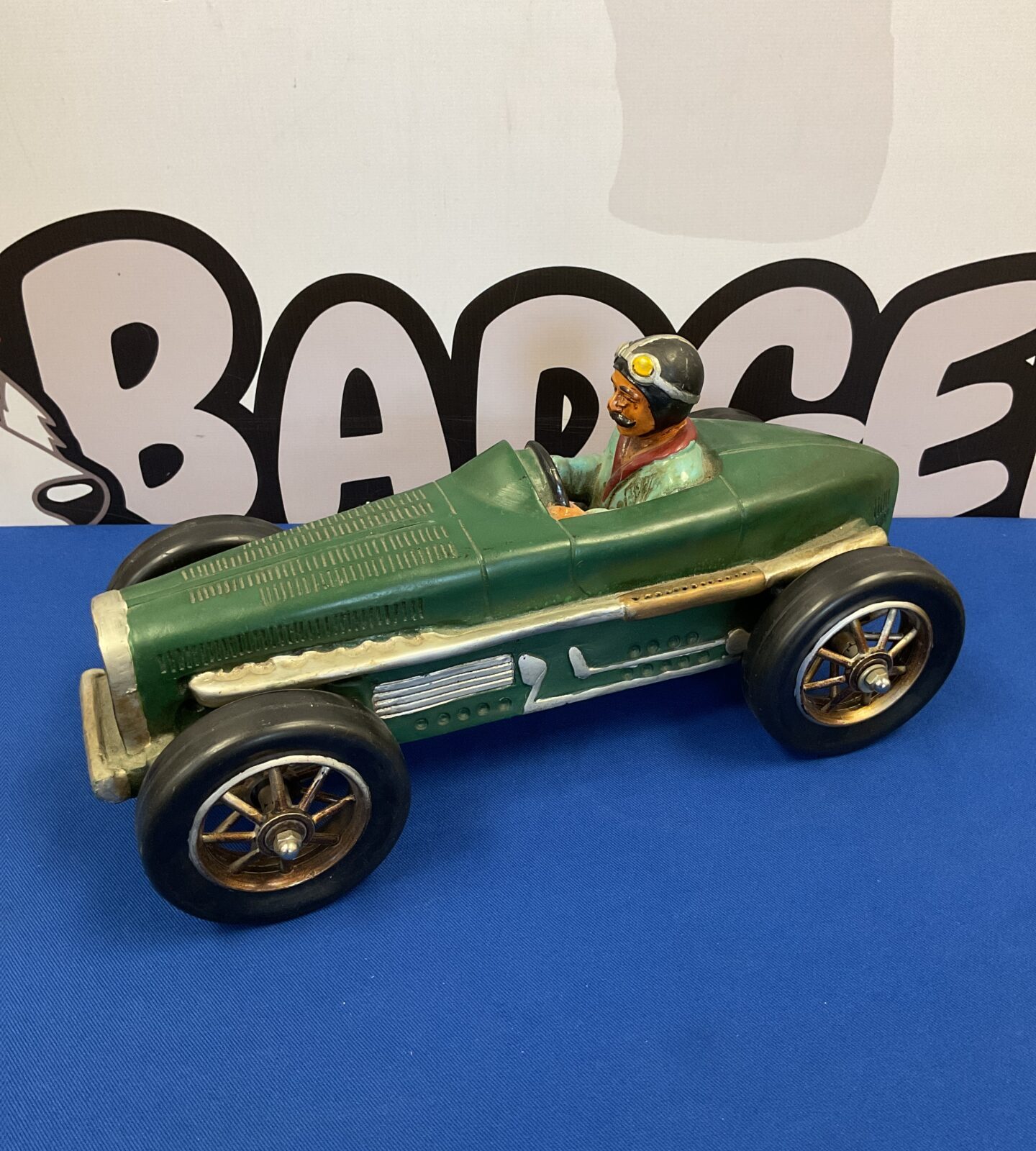 Vibrant green resin classic race car model for display.