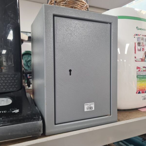 Grey metal strong safe with key for secure storage.