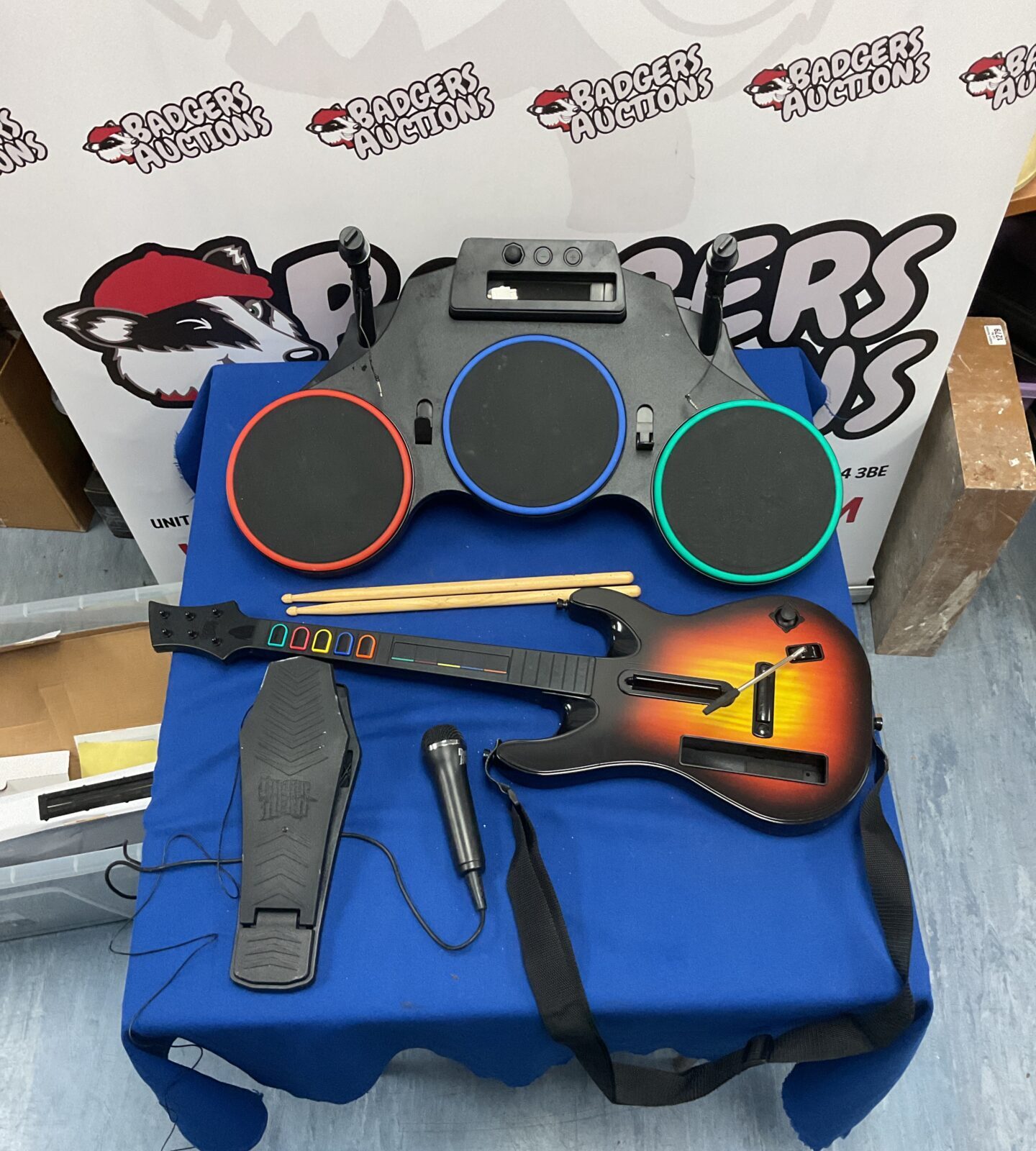 Complete Guitar Hero bundle with guitar, drum kit, and microphone.