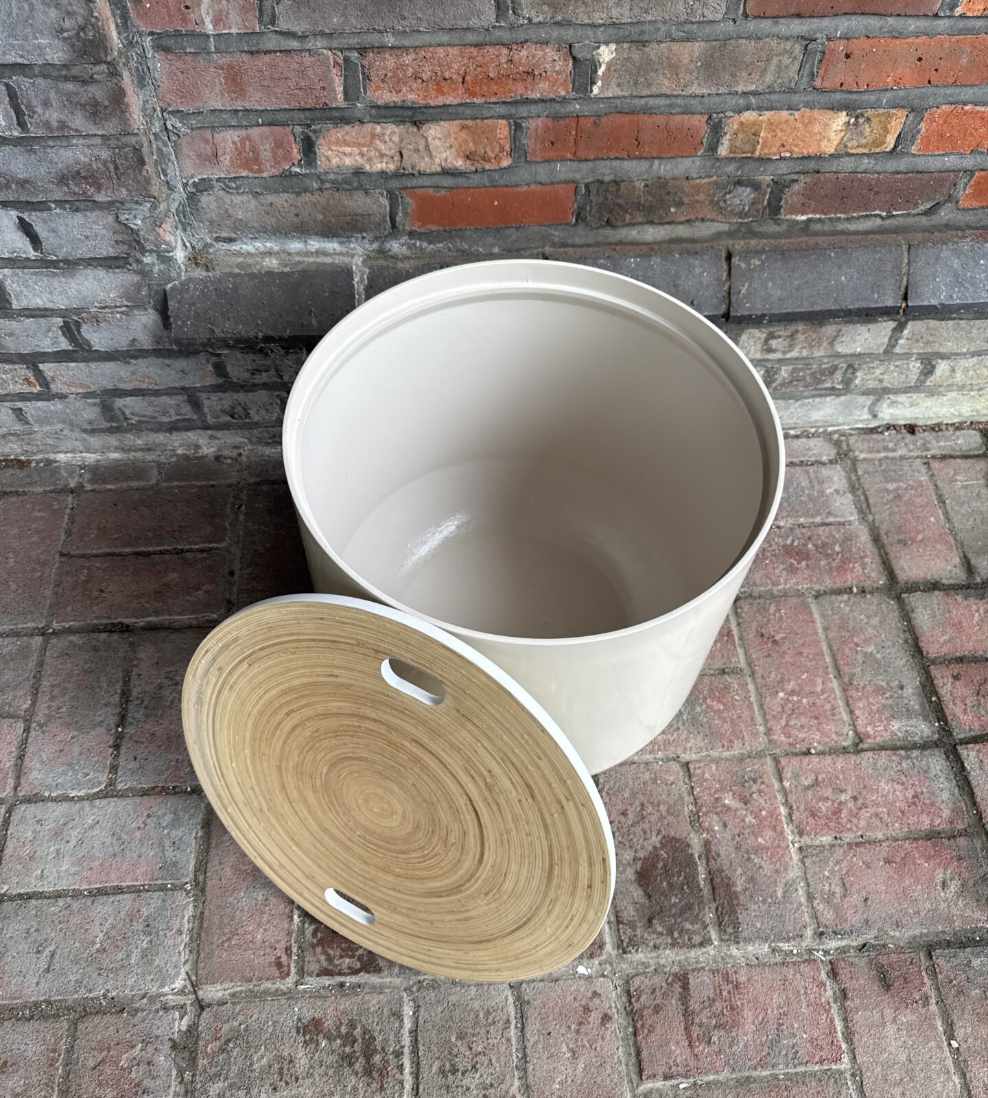 Close-up of Habitat drum table reversible wood grain top.