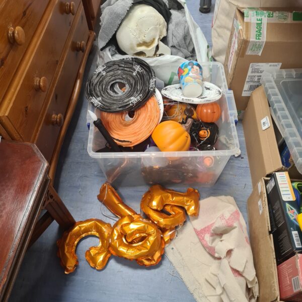 A lot of Halloween decorations including pumpkins and a skull.