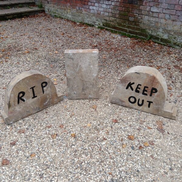 Set of three weathered Halloween headstones for spooky garden decor.